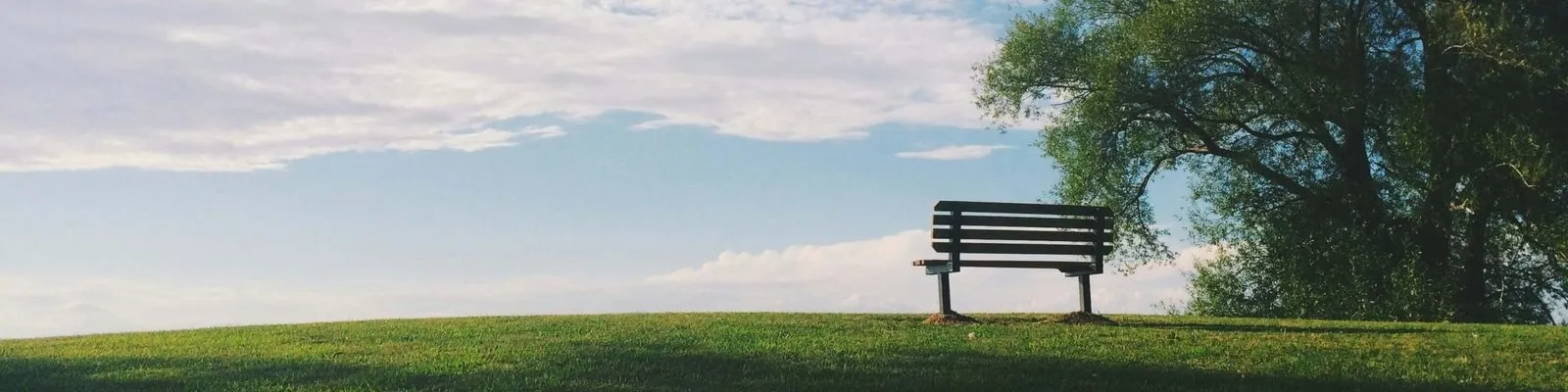 empty park bench and sky representing wrongful death