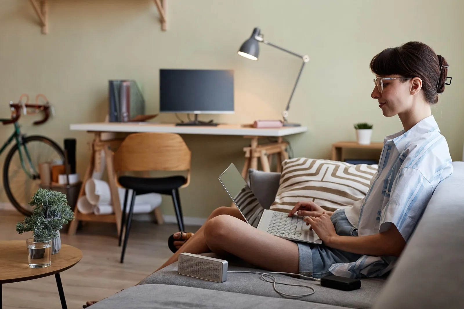 Side view portrait of smiling young woman using laptop to research personal injury attorneys