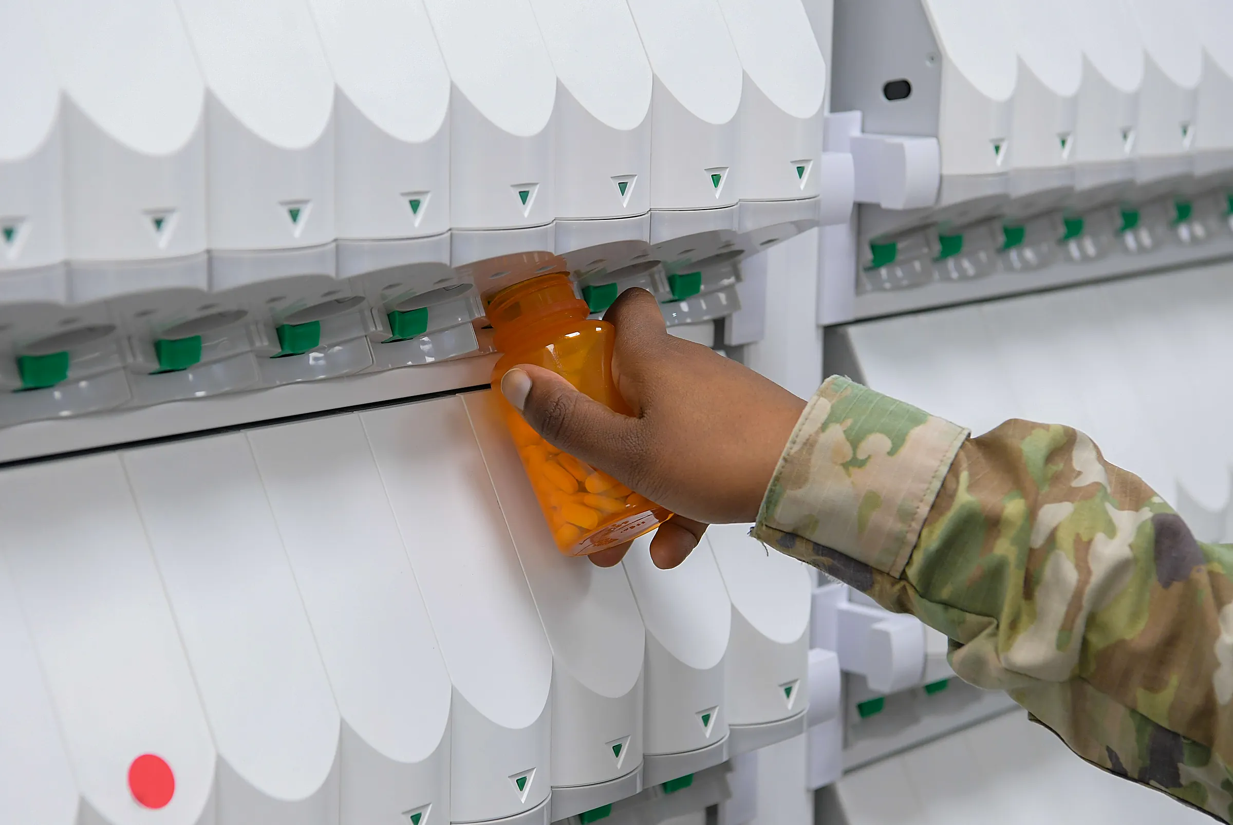 Pharmacy technician filling a prescription bottle