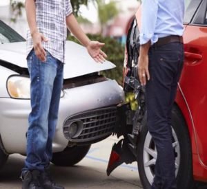 Two men talk after a car accident