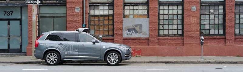 An Uber self driving car on a city street.