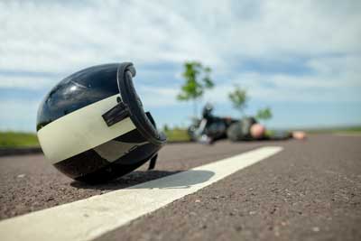 Man lying on the ground after a motorcycle accident. 