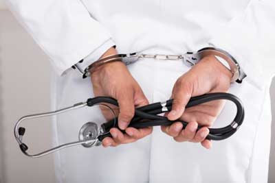 A doctor in handcuffs in Lawrenceville