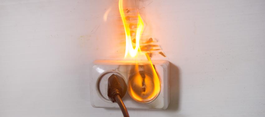 A faulty wiring issue causing an outlet to catch fire.