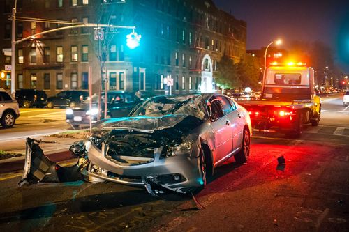 Image is of a car accident scene at night, concept of Carrollton car accident lawyer